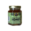 Jar of ginger-flavored honey on a white background